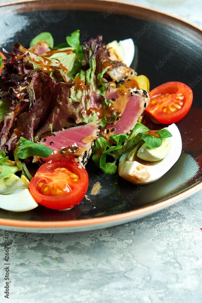 Warm Tuna Salad. Beautiful serving dishes. Light gray background. Restaurant menu