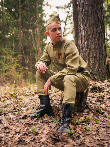 Man in soviet war uniform in forest. Victory day reenactment © paulzhuk
