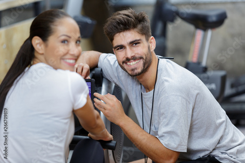 woman and man on rowing machines