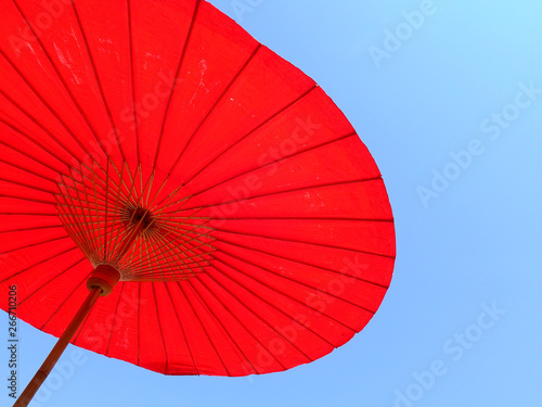 red umbrella with blue sky background