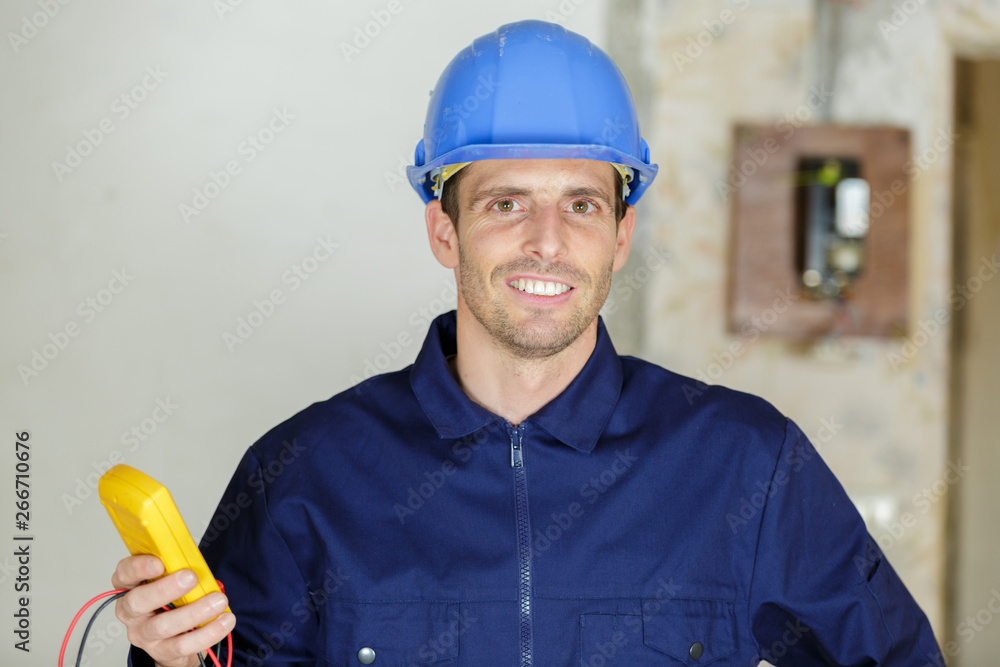happy electrical engineer looking at the camera happy electrical engineer looking at the camera