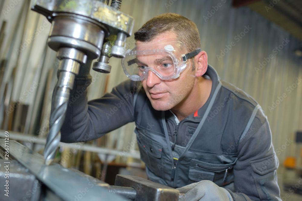 man using industrial sized drill man using industrial sized drill