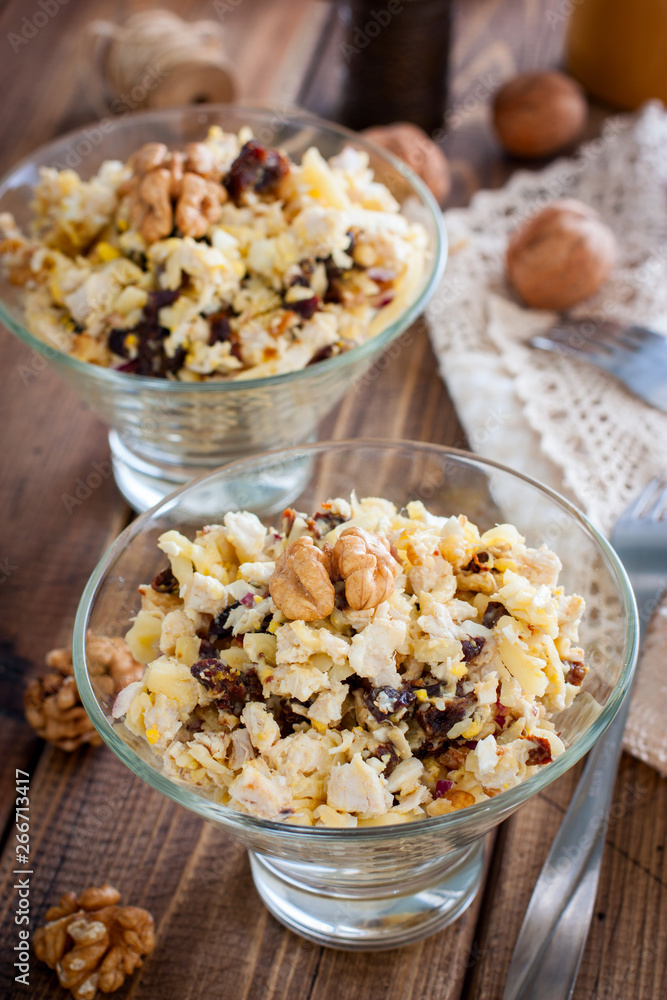Salad of walnut, chicken and prunes in glass salad bowls, selective focus Salad of walnut, chicken and prunes in glass salad bowls, selective focus
