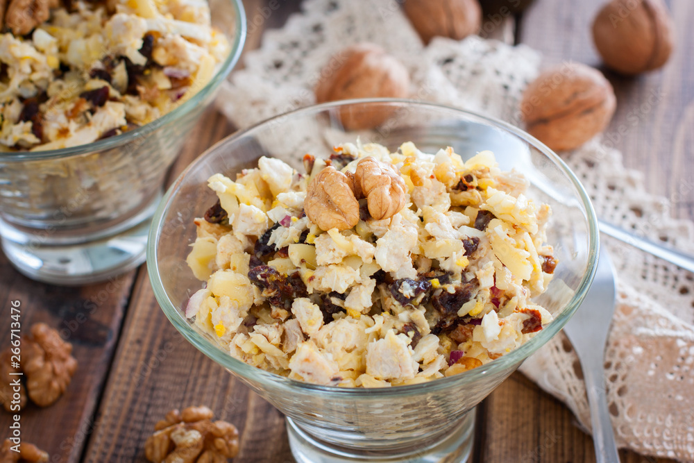 Festive salad of walnut, chicken and prunes in glass salad bowls, horizontal Festive salad of walnut, chicken and prunes in glass salad bowls, horizontal