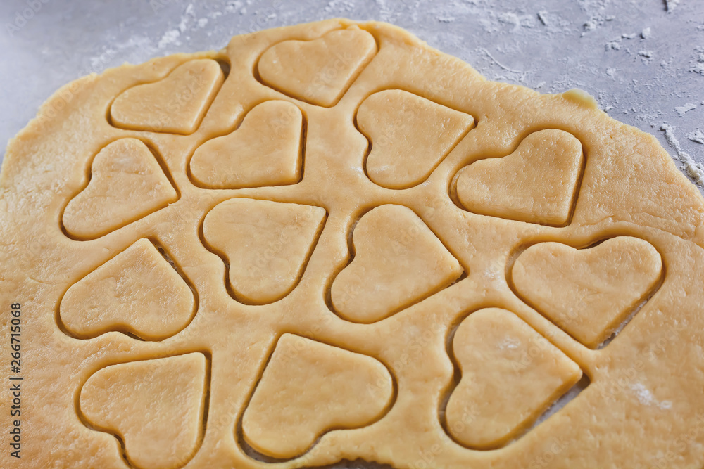 Dough. The process of making cookies and gingerbread at home. Heart-shaped cookies, pattern