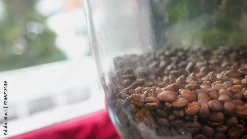 Closeup shoot of coffee beans placed in a coffee press machine indoors in a cafe Closeup shoot of coffee beans placed in a coffee press machine indoors in a cafe