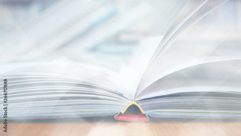 Blurred image, open book page on wood desk in the library room for business and  education background, back to school concept - obrazy, fototapety, plakaty 