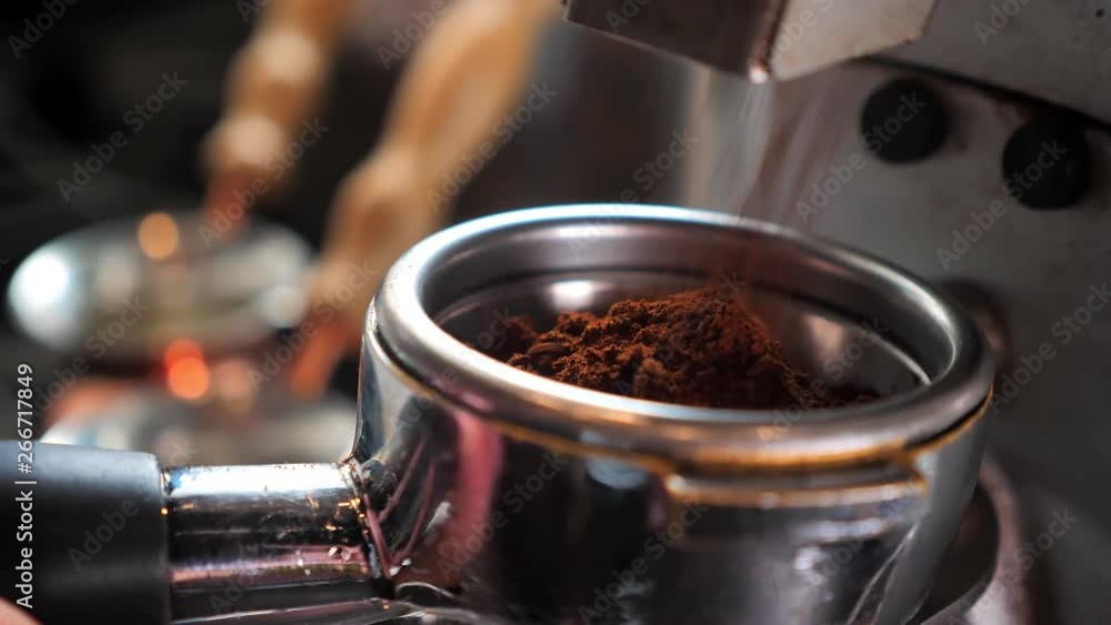 Closeup shoot of coffee beans being freshly grinded in a coffee blending machine indoors in a cafe