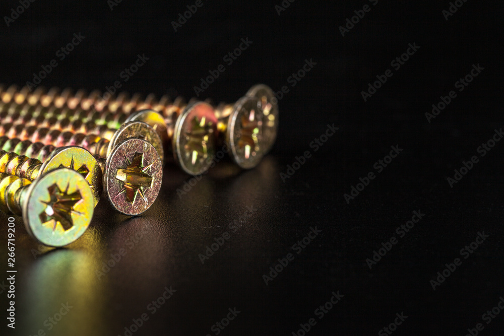screws on black background screws on black background