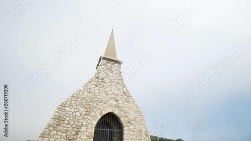 Close-up view of light brick dome with prison lattice against gray cloudy sky. Action. Old church built in Europe photo