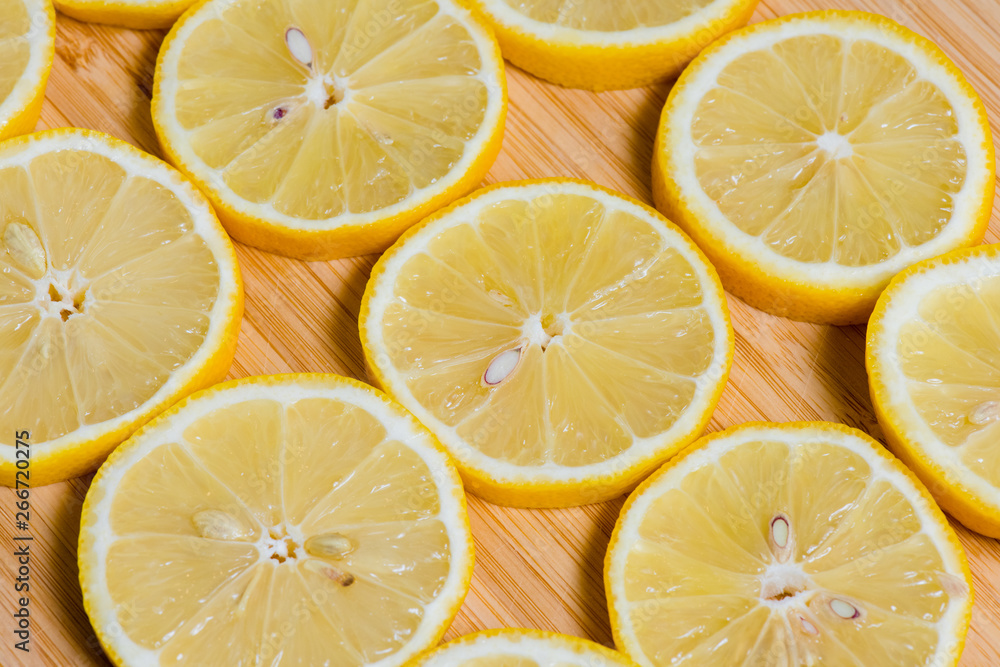 Fresh yellow lemons slices on a wooden background.. sweet lime, vitamin c. Lemon slices Fresh yellow lemons slices on a wooden background.. sweet lime, vitamin c. Lemon slices