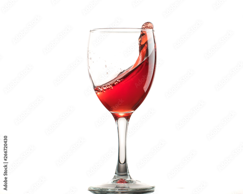 A glass of red wine on a white or black background with splashes. A glass of red wine on a white or black background with splashes.