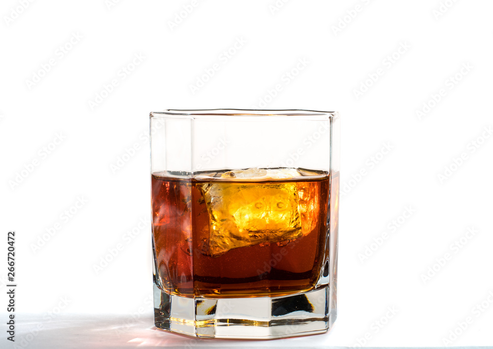 Fallen and falling whiskey glass with ice and splashes Fallen and falling whiskey glass with ice and splashes