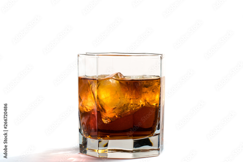 Fallen and falling whiskey glass with ice and splashes Fallen and falling whiskey glass with ice and splashes