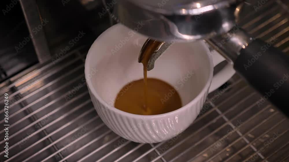 Closeup shoot of coffee being poured into a cup using the three-compartment sink in a cafe indoors Closeup shoot of coffee being poured into a cup using the three-compartment sink in a cafe indoors