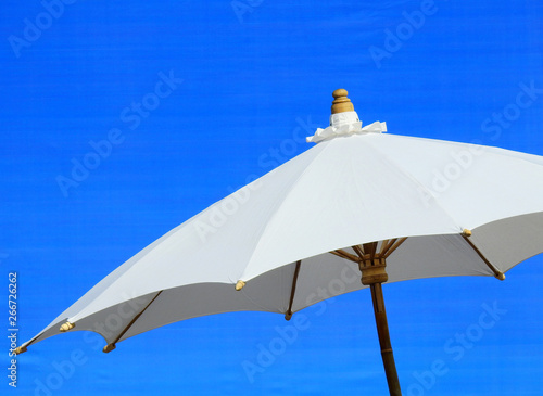 White umbrella with blue background