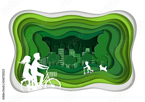 couples are cycling on a green lawn enjoying a relaxing vacation. green city concept. paper art