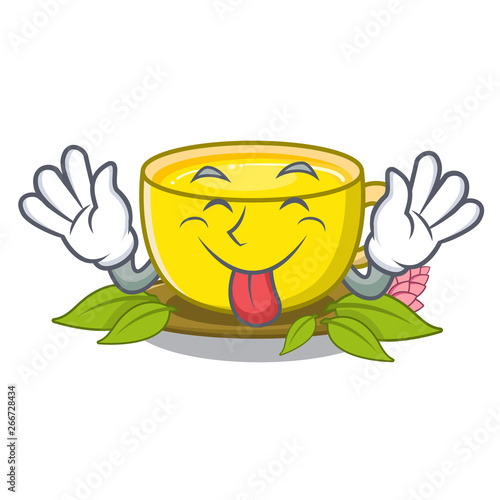 Tongue out turmeric tea above mascot wood table