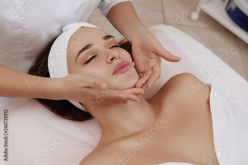 Face Massage of a Young Woman Getting Spa Treatment.