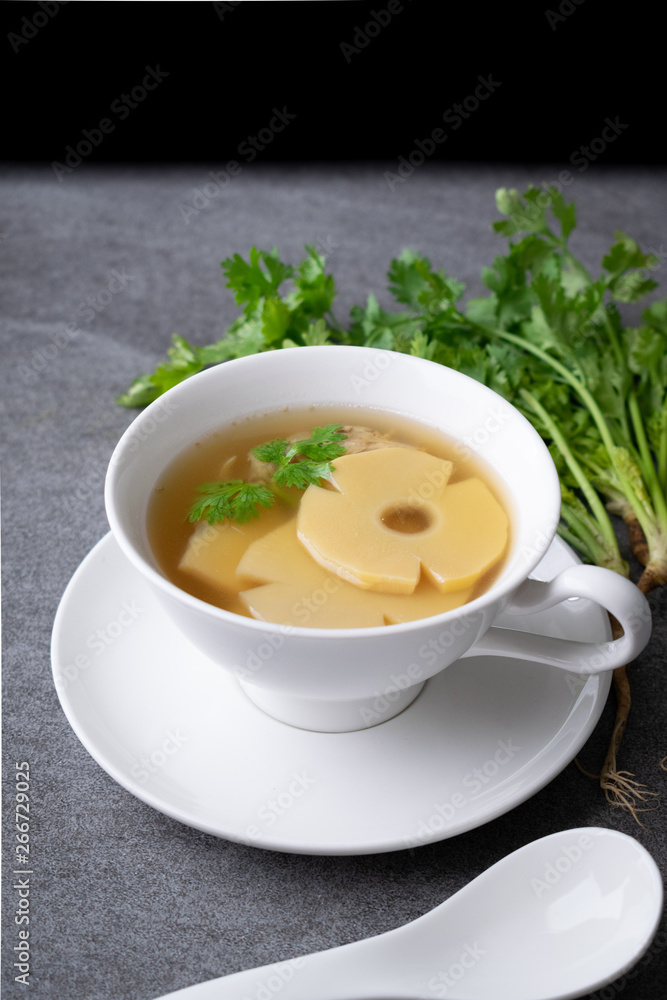 Bamboo shoot soup or bamboo shoot boiled with pork in white bowl on the concrete table background. Bamboo shoot soup or bamboo shoot boiled with pork in white bowl on the concrete table background.