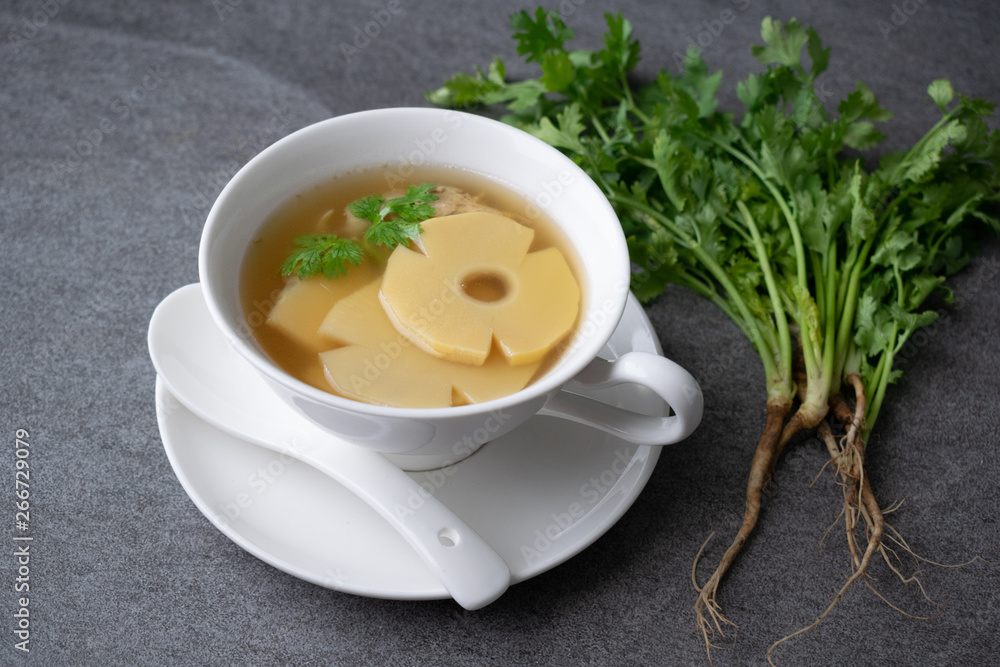 Bamboo shoot soup or bamboo shoot boiled with pork in white bowl on the concrete table background. Bamboo shoot soup or bamboo shoot boiled with pork in white bowl on the concrete table background.