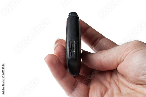 Black key of a car in hand isolated on a white background. Car key