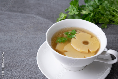 Bamboo shoot soup or bamboo shoot boiled with pork in white bowl on the concrete table background.