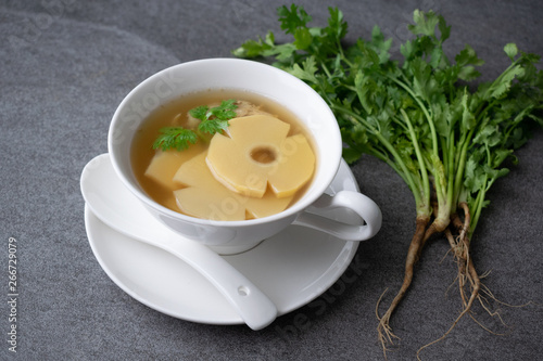 Bamboo shoot soup or bamboo shoot boiled with pork in white bowl on the concrete table background.