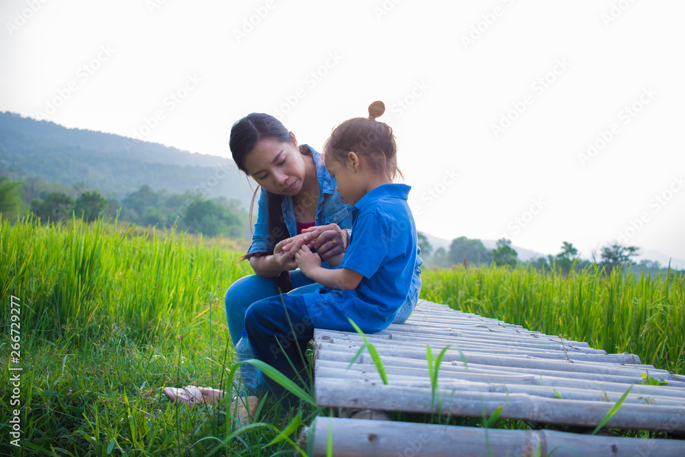 Young mother hugging and soothing a crying little long hair boy, Asian mother trying to comfort and calm down her crying child Young mother hugging and soothing a crying little long hair boy, Asian mother trying to comfort and calm down her crying child