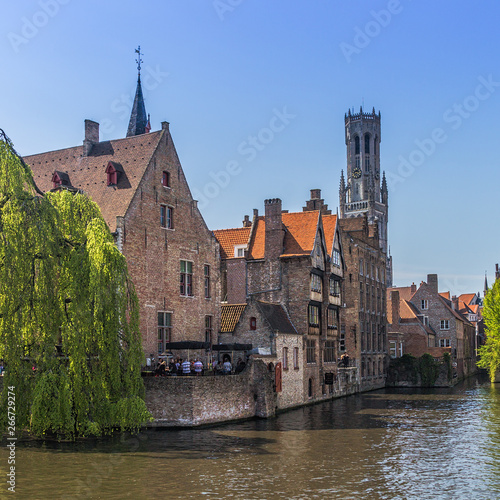 Beautiful canal and traditional houses in the old town of Bruges photo