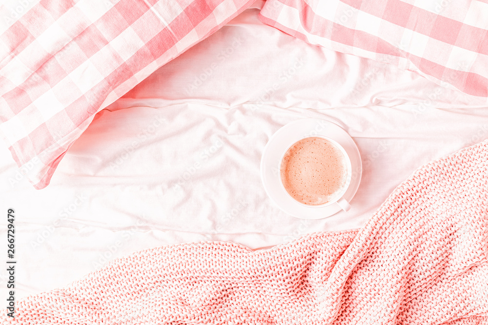 Bed with pink knitted plaid, coffee and macaroons. Bed with pink knitted plaid, coffee and macaroons.