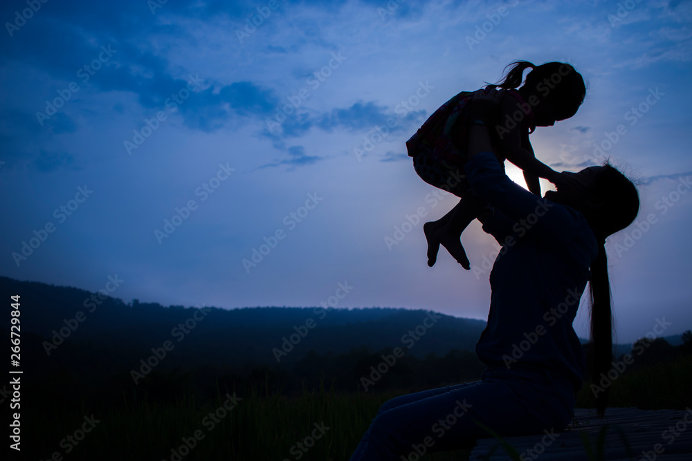 Happy Mother and her child play outdoors having fun, mother lifting daughter in rice field. Happy Mother and her child play outdoors having fun, mother lifting daughter in rice field.
