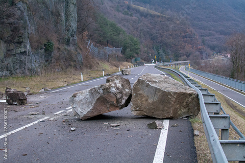 rockfall on the mainroad in dolomites area, northern Italy.  Big boalder on the road. danger zone photo