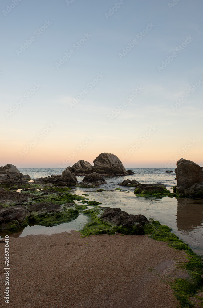Beach and rocks at sunset in Lloret de Mar Beach and rocks at sunset in Lloret de Mar