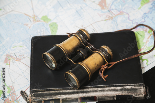 Ancient binoculars lie on book