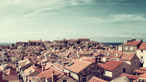 Dubrovnik Old City red tiled roofs, panoramic view from the ancient city wall, scenic cityscape. World famous and most visited historic city of Croatia, UNESCO World Heritage site, travel background