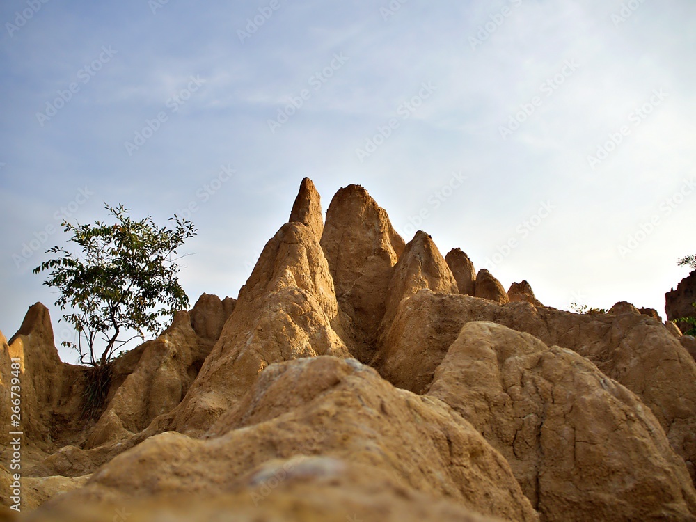 The eye trail shot to the sand mountain with blue sky and the morning sun shine at Sao Din Na Noi park, Nan, Thailand