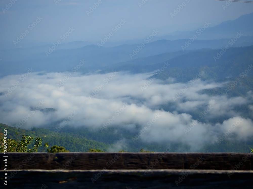 Landscape of the fog over the mountain valley with wooden bar in the morning at Doi Samur Dao, Nan, Thailand