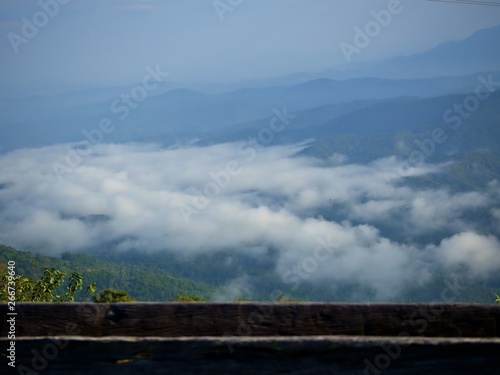 Landscape of the fog over the mountain valley with wooden bar in the morning at Doi Samur Dao, Nan, Thailand