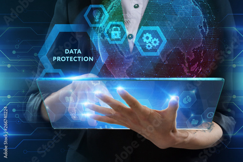 The concept of business, technology, the Internet and the network. A young entrepreneur working on a virtual screen of the future and sees the inscription: Data protection