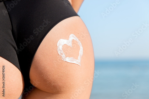 Wallpaper Mural Heart shape made of sun cream on a woman buttocks over the sea background Torontodigital.ca