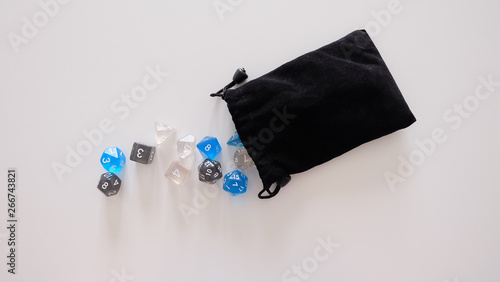 A set of dices for board games and roleplay games falling out of the bag