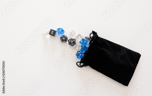 A set of dices for board games and roleplay games falling out of the bag