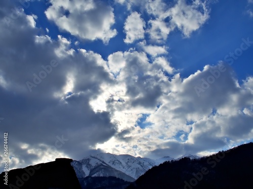 The blue sky with cloud during the sunset and the snow mountain at the horizon in Shirakawago, Japan in Spring