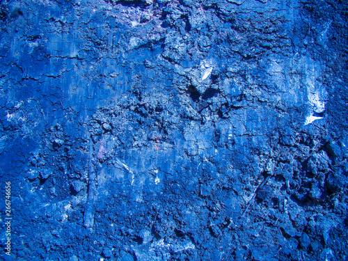 Background of dense cut clay. The main color is cobalt blue. White inclusions, cracks, texture. photo