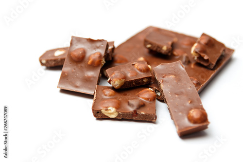 pieces of chocolate with hazelnuts on white background