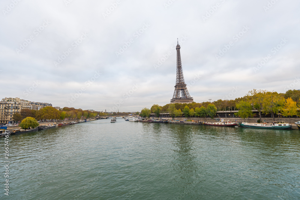 Paris Eiffel Tower and river Seine at sunset in Paris, France. Eiffel Tower is one of the most iconic landmarks of Paris