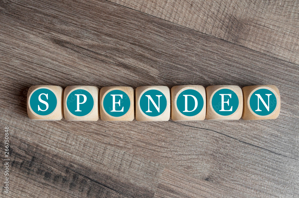 Fototapeta premium Würfel mit dem Begriff Spende