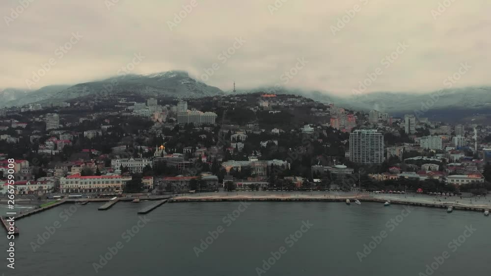 Aerial view of Yalta embankment from air in winter day. City on mountains and coastline with buildings and beautiful nature, Crimean resort Aerial view of Yalta embankment from air in winter day. City on mountains and coastline with buildings and beautiful nature, Crimean resort