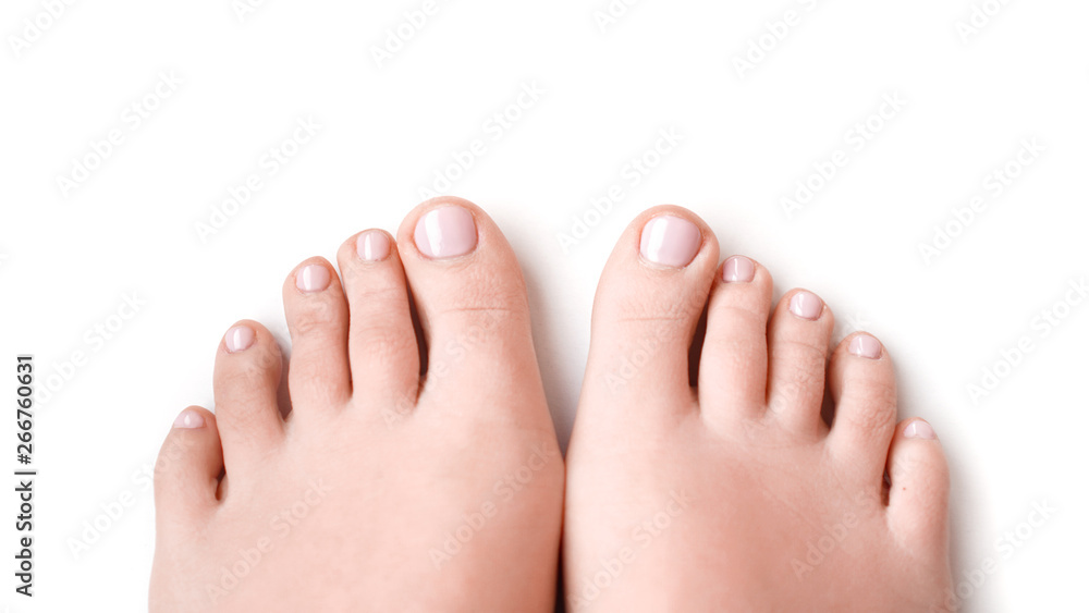 Woman feet with soft pink manicure isolated on white background Woman feet with soft pink manicure isolated on white background